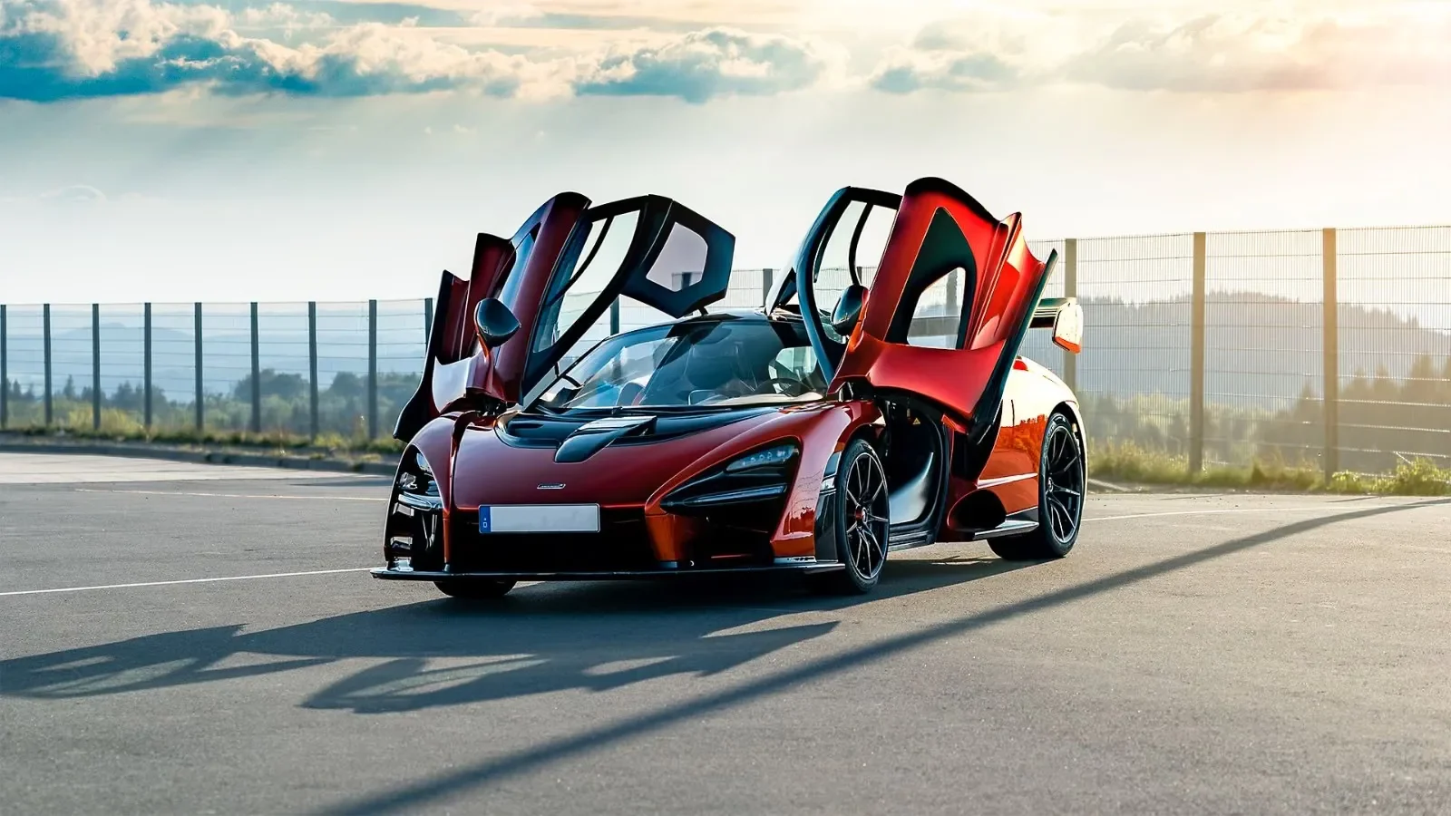 McLaren Senna in Volcano Orange offered by Claudia Soujon Supercars, doors open at sunset