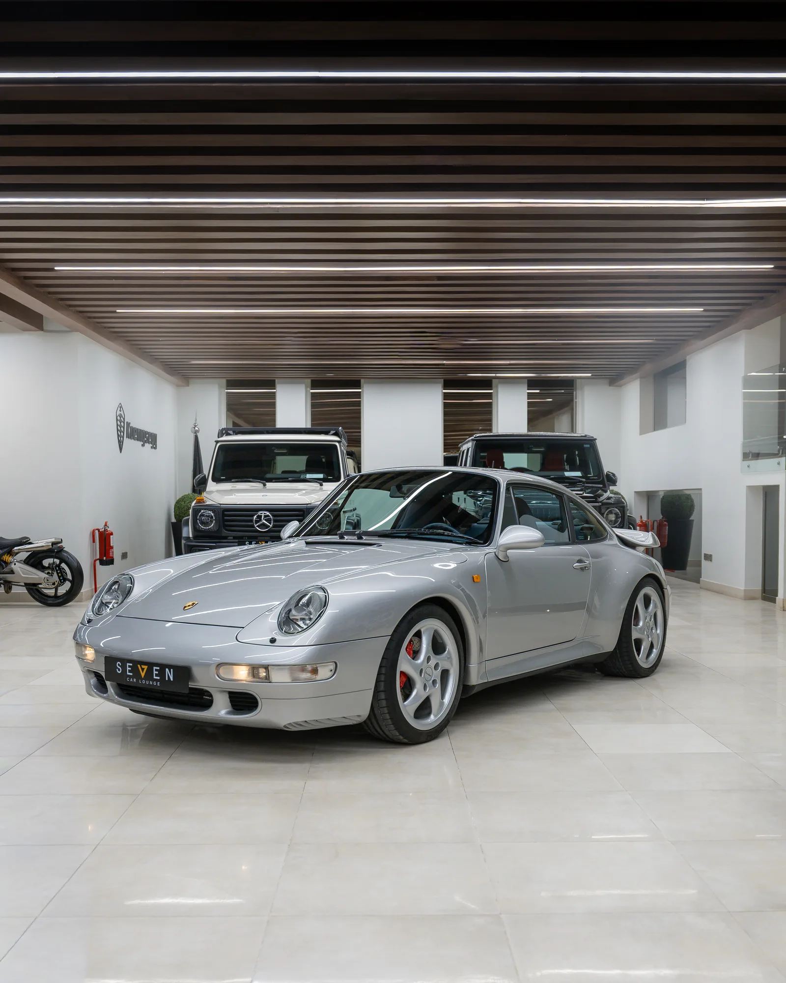 Polar Silver Porsche 911 Turbo (993), front three-quarter view in the SEVEN Car Lounge showroom in Riyadh