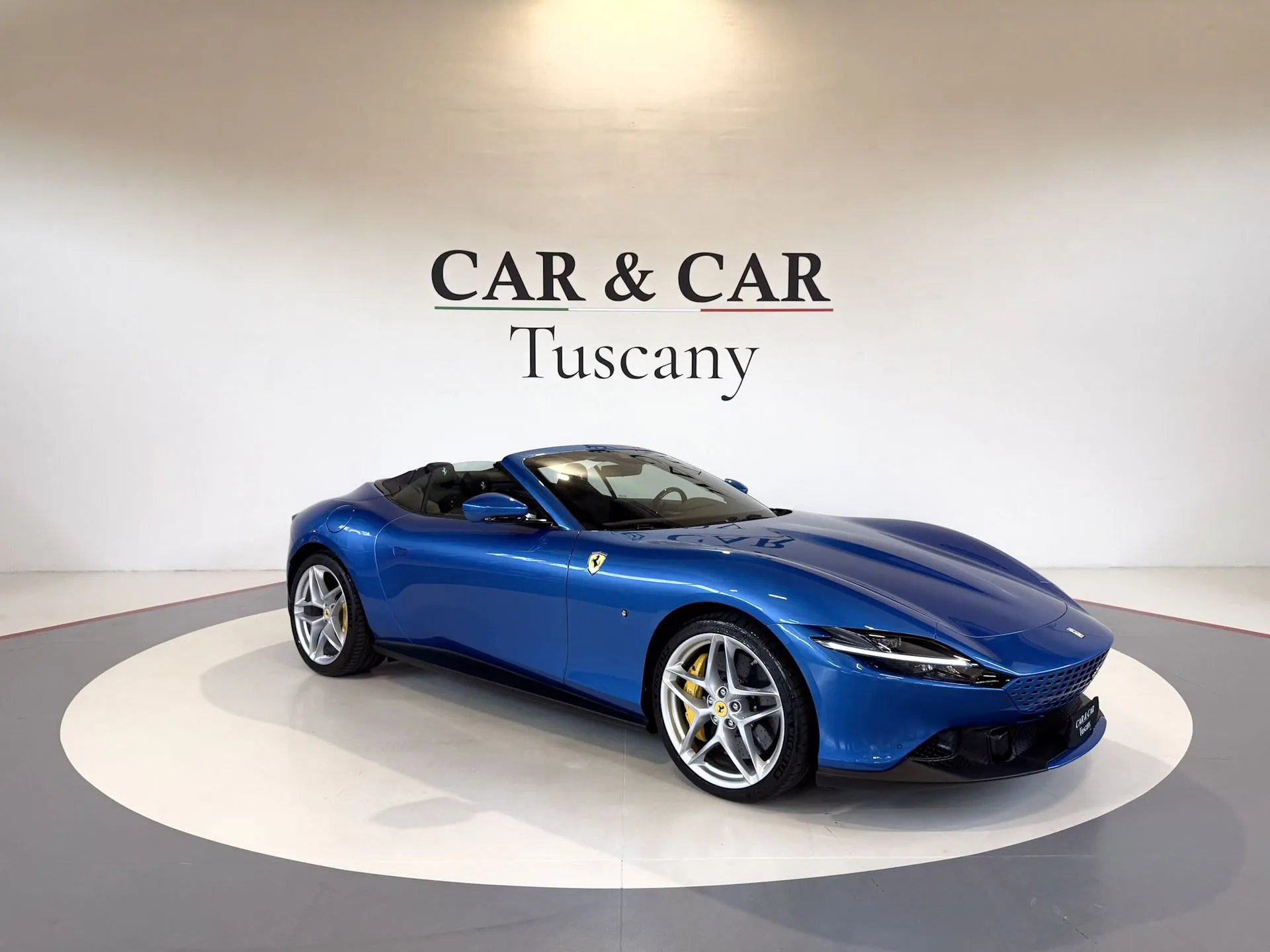 Blu Corsa 2025 Ferrari Roma Spider at Car & Car Tuscany in Lucca, front three-quarter view